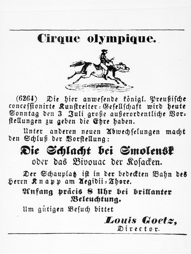 Plakat auf dem ein langer Werbetext für den Cirque olympique steht. Angekündigt wird, dass eine Schlacht nachgestellt werden soll. 