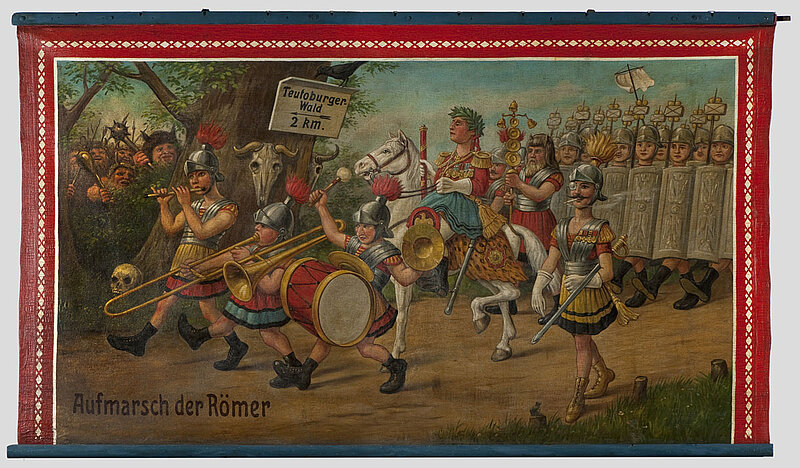 Gemälde: Comichafte Darstellung einer römischen Armee. Im Wald warten Barbaren. Ein Schild verkündet "Teutoburger Wald 2 km". Weiterer Text: Aufmarsch der Römer